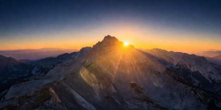 Warm sunset light over rolling foggy mountain hills